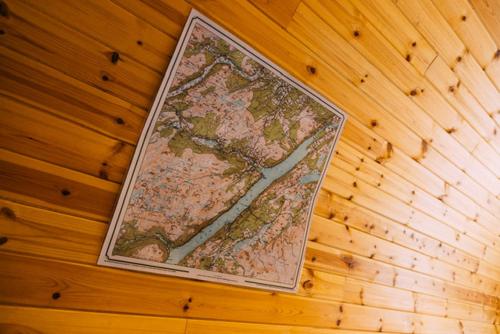 a tapestry hanging on a wall in a room at Loch Ness Woodland Pods in Drumnadrochit