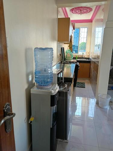 a kitchen with a trash can with a plastic bag on top of it at ROYAL APARTMENT MAKUPA in Mombasa