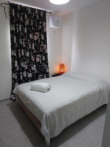 a bedroom with a bed with a black and white curtain at Dudger apartment 