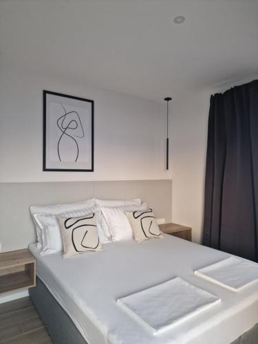 a white bed with white pillows in a bedroom at MA Apartments in Senj