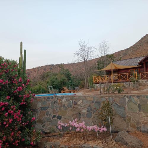 a resort with a swimming pool and a building at Cabañas Ocoa in Hijuelas