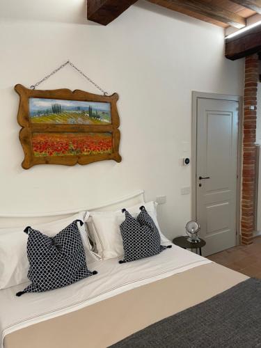 a bedroom with a large white bed with pillows at MontepulcianoLettings in Montepulciano