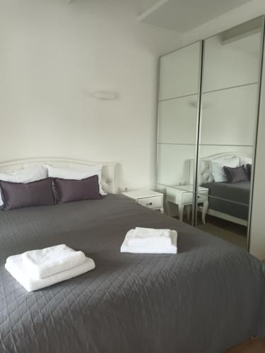 a bedroom with a bed with two towels on it at GoPalanga in Palanga