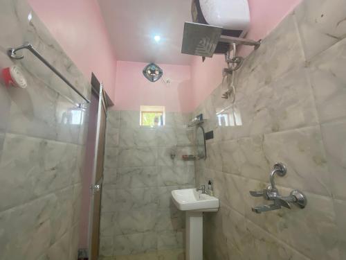 a bathroom with a shower and a toilet and a sink at Lagnalaya- Your Next Home in Rājgīr
