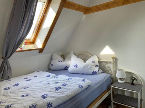 een slaapkamer met een bed met blauwe en witte kussens bij Haus Mariechen in Hooksiel