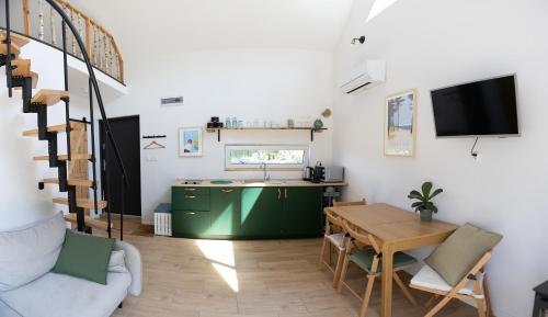 a living room with a table and a green cabinet at Brzozlove in Nadole