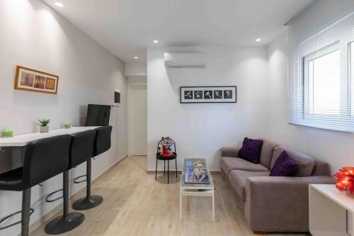 a living room with a couch and a piano at Luxury cozy appartment in the city center in Rhodes Town