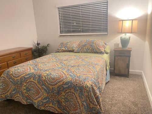 a bedroom with a bed and a dresser and a window at Miami Gallery Private Queen Bedroom and Shared Bathroom in Oxford