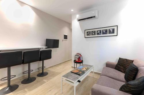 a living room with a couch and a table at Luxury cozy appartment in the city center in Rhodes Town