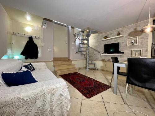 a bedroom with a bed and a desk and a tv at Living Dalia in Carovigno