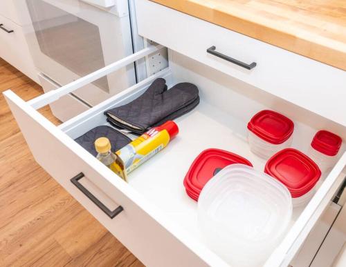 a drawer in a kitchen with red plates and utensils at Newly Remodeled Family Friendly Home in Page