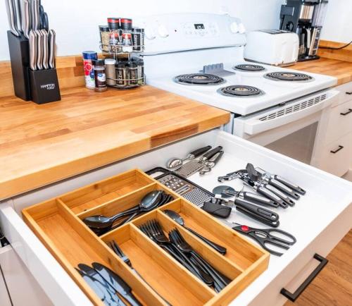 a kitchen counter with a drawer with utensils on it at Newly Remodeled Family Friendly Home in Page
