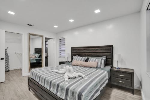 a large bedroom with a large bed with a white comforter at The Lake House in Fort Lauderdale in Fort Lauderdale