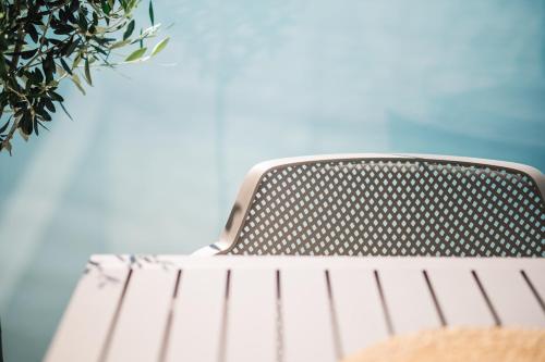 a metal bench with the sky in the background at KAAB Boutique Hotel in Ulcinj