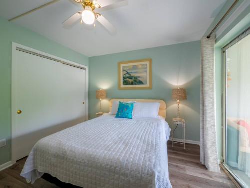 a bedroom with a bed and a ceiling fan at Wesley Paradise ☆Chic 1BD + Private Balcony & Pool in Ocean City