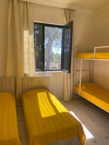 a room with two bunk beds and a window at Maguli Home Gonio in Gonio