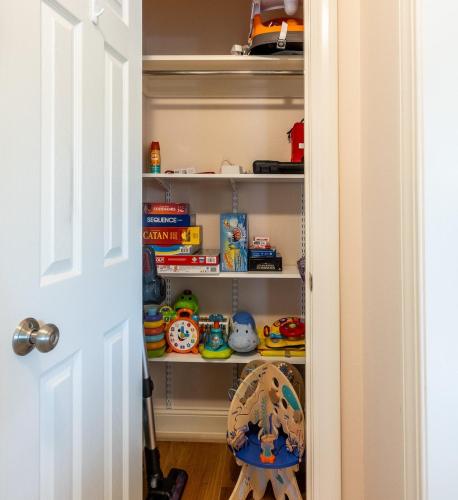 a childs closet with toys on shelves at CozyLiving in Billings