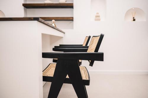 a black table and two chairs in a room at KAAB Boutique Hotel in Ulcinj
