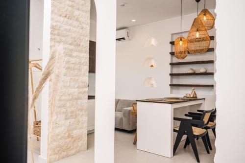 two views of a kitchen and a living room with a table and chairs at KAAB Boutique Hotel in Ulcinj
