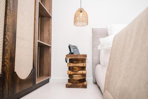 a bedroom with a bed and a stack of logs at KAAB Boutique Hotel in Ulcinj