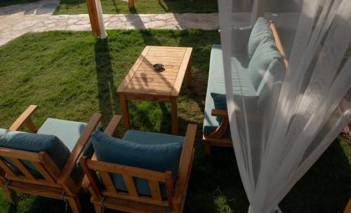 a view of a table and chairs in a yard at Mavi Yaprak Hotel in Oludeniz