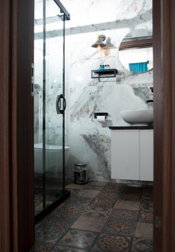 a bathroom with a shower and a sink at Mavi Yaprak Hotel in Oludeniz