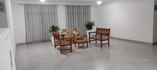 a dining room with four chairs and a table at Jaguaré Hotel in Sao Paulo