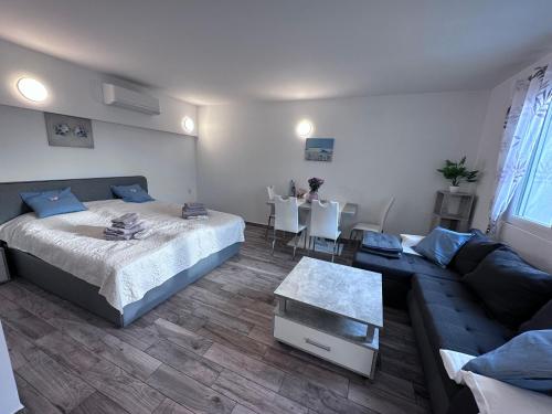 ein Wohnzimmer mit einem Bett und einem Sofa in der Unterkunft Sunny Apartments Podersdorf am See in Podersdorf am See