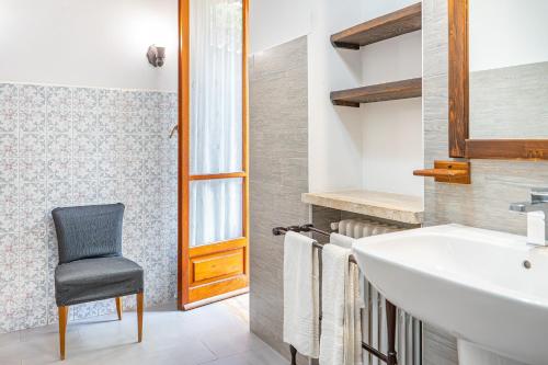 a bathroom with a sink and a chair in it at B&B Dolce Sosta in Palinuro