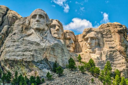 a statue of three faces on a mountain at Comfort Inn & Suites Rapid City near Mt Rushmore in Rapid City