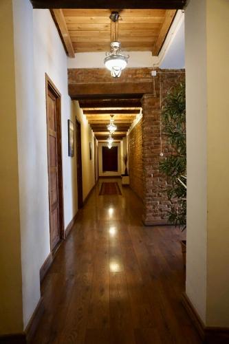 an empty hallway with a brick wall and wooden ceilings at Old Sighnaghi in Sighnaghi