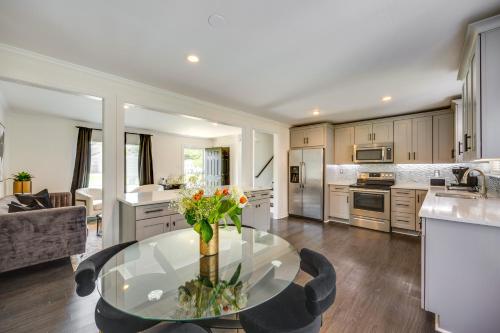 a kitchen with a glass table with flowers on it at Modern Richmond Home with Deck, Close to Downtown! in Richmond
