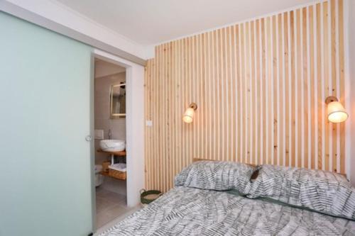 a bedroom with a bed and a bathroom at Mati in Labin