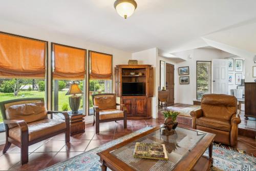 a living room filled with furniture and a table at Pipe Creek Escape with Screened-In Porch and Hot Tub! in Pipe Creek