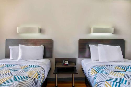 two beds sitting next to each other in a room at Motel 6-Conyers, GA in Conyers