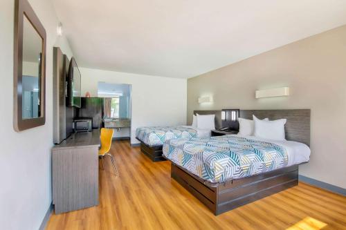 a hotel room with two beds and a television at Motel 6-Conyers, GA in Conyers