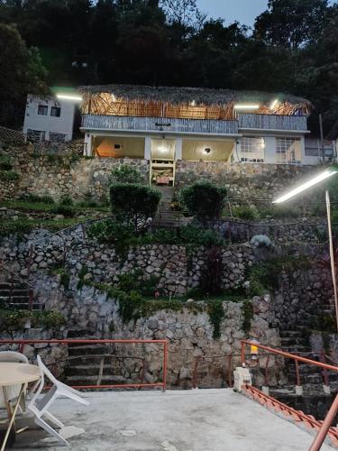 a house on top of a stone wall at Hotel Restaurante La Villa de los Dioses in San Antonio Palopó