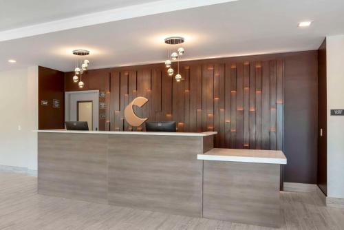 a hotel lobby with a reception counter with a sign at Comfort Inn & Suites Destin near Henderson Beach in Destin