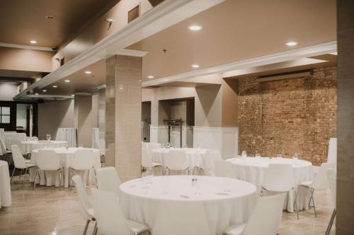 un salón de banquetes con mesas blancas y sillas blancas en CityFlatsHotel - Grand Rapids, Ascend Hotel Collection, en Grand Rapids