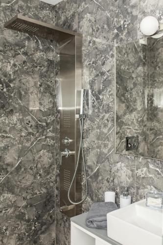 a bathroom with a shower and a sink at Four Princess in Agia Paraskevi