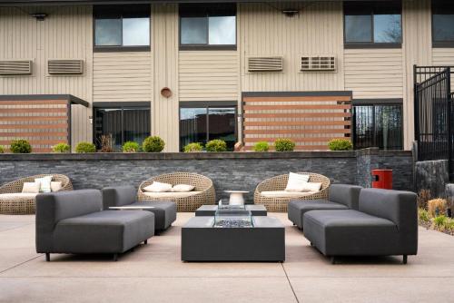 a patio with couches and tables and a building at Ruby River Hotel in Spokane