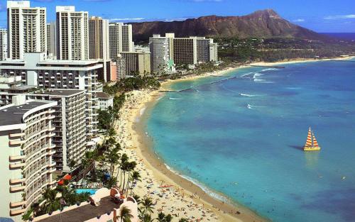 a view of a beach with a sailboat in the water at Great Ocean View Condo, Near Beach with Free Parking! in Honolulu