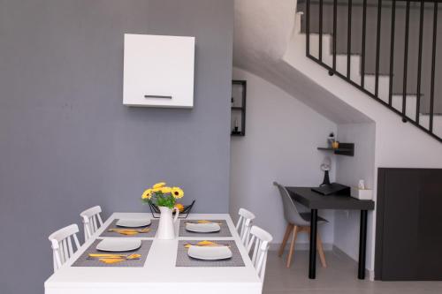 a dining room with a table and a table and chairs at Four Princess in Agia Paraskevi