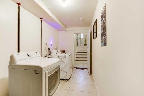 a bathroom with a sink and a washing machine at Spacious Newark Duplex in Walkable Location! in Newark