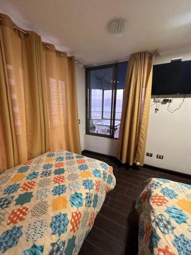 a bedroom with a bed and a large window at Departamento con vista al mar in Iquique