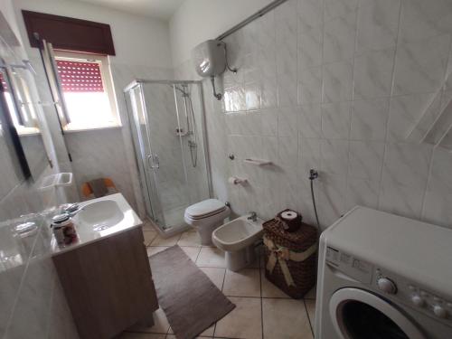 a bathroom with a shower toilet and a sink at Corte Lavito in Tuglie