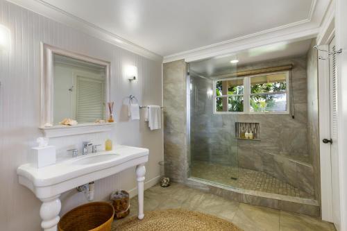 a bathroom with a sink and a shower at Classic 3br Oceanfront Cottage - Alekona Kauai in Koloa