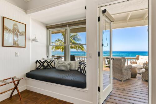 a room with a window seat with a view of the ocean at Classic 3br Oceanfront Cottage - Alekona Kauai in Koloa