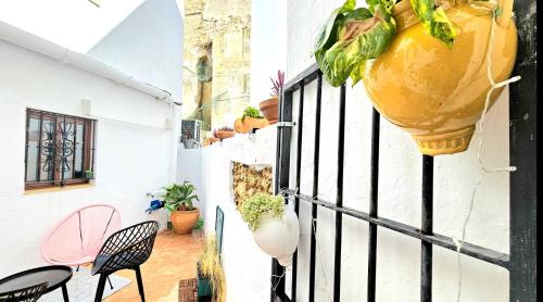 a balcony with a large vase hanging on a wall at Casa Bakara Vejer old town in Vejer de la Frontera