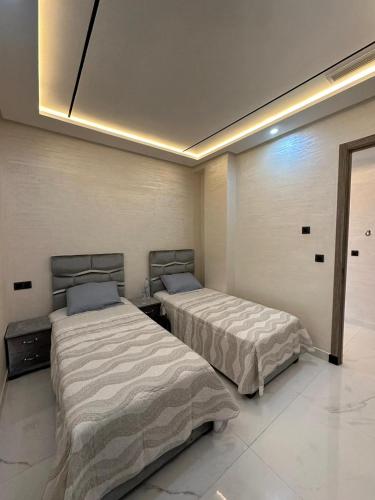 two beds in a room with two beds sidx sidx sidx at اقامة الانوار in Nador